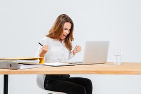 angry-young-businesswoman-using-laptop-and-shouting-over-white-background