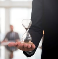 businessman-holding-an-hour-glass-signifies-the-importance-of-being-on-time