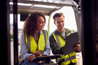 male-and-female-staff-operating-fork-lift-truck-in-2022-03-17-15-09-48-utc