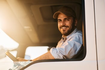 portrait-of-happy-truck-driver-looking-at-camera-2023-11-27-05-02-46-utc