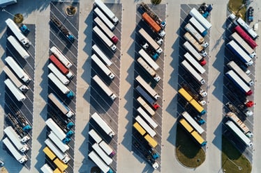 top-view-parking-lot-with-parked-trucks-2022-12-16-12-46-35-utc